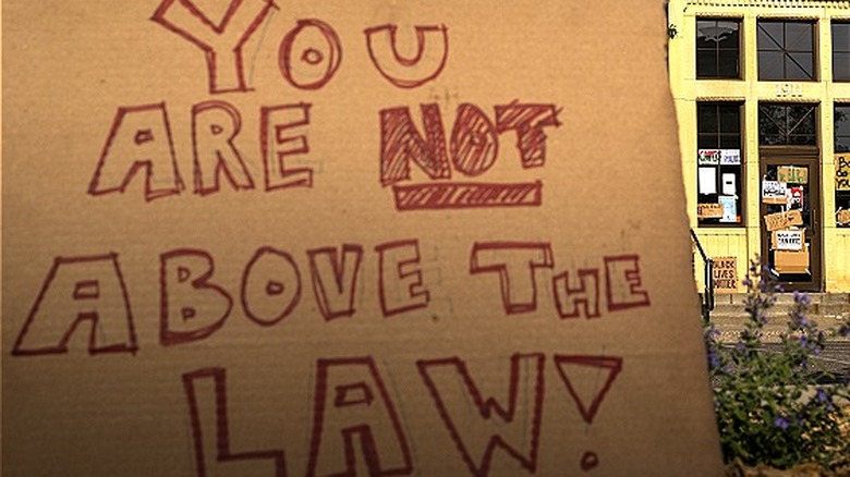 Protester's sign at police station