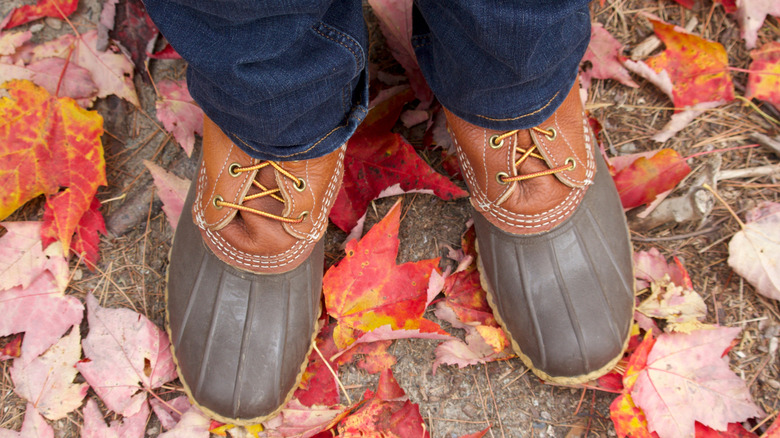 LL Bean boots standing in autumn leaves
