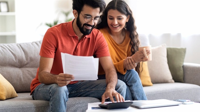 Smiling couple working on finances