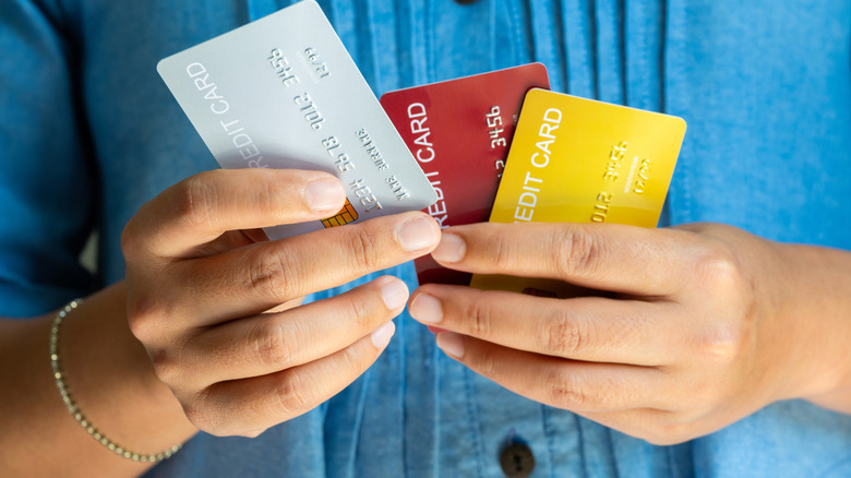 a person holding credit cards