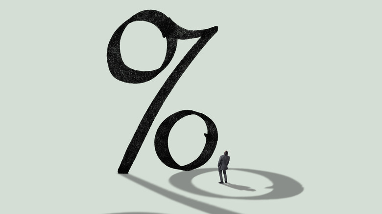 giant percentage sign, small person