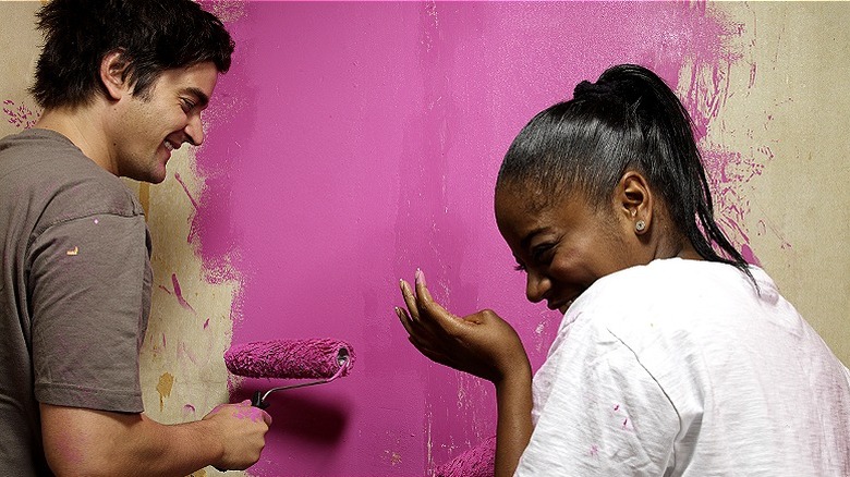 A couple painting their walls