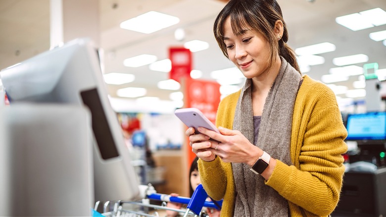 Person checking out with phone
