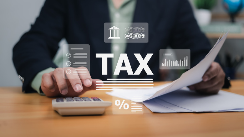 tax superimposed over a person calculating expenses