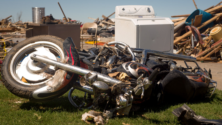 debris, including a wrecked motorcycle, in aftermath of tornado strike