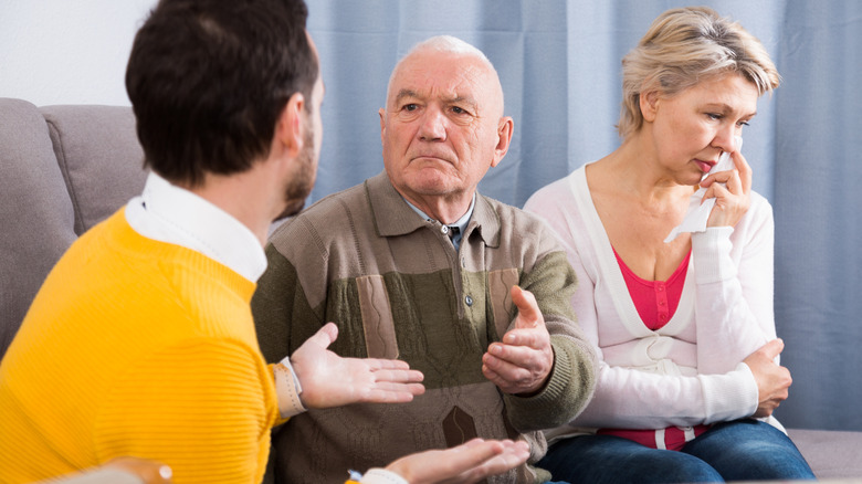 A senior having a disagreement with younger family member