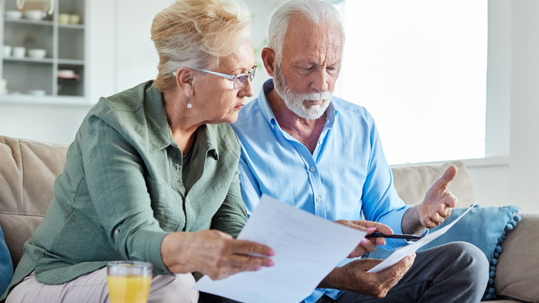 Older couple looking upstate going over bills