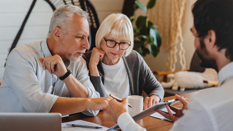 Older couple meeting with financial advisor.