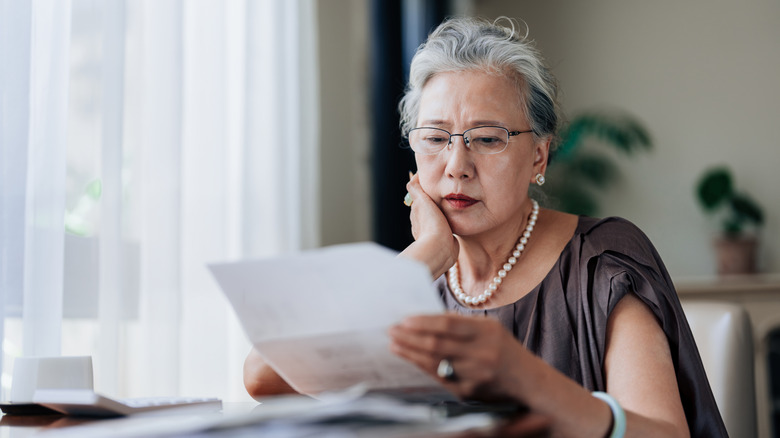 Women with concerned look viewing a statement.