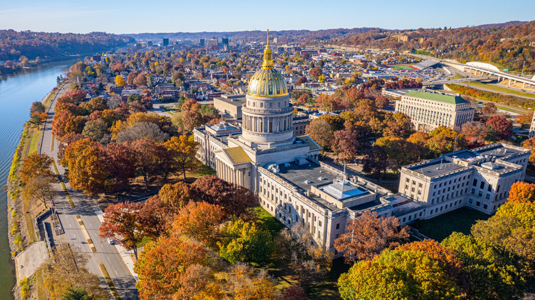 An aerial view of the West Virginia State Capitol Building and downtown Charleston with fall foliage