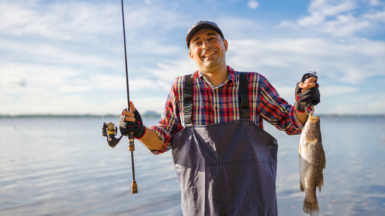 Man with a fishing pole and a caught fish