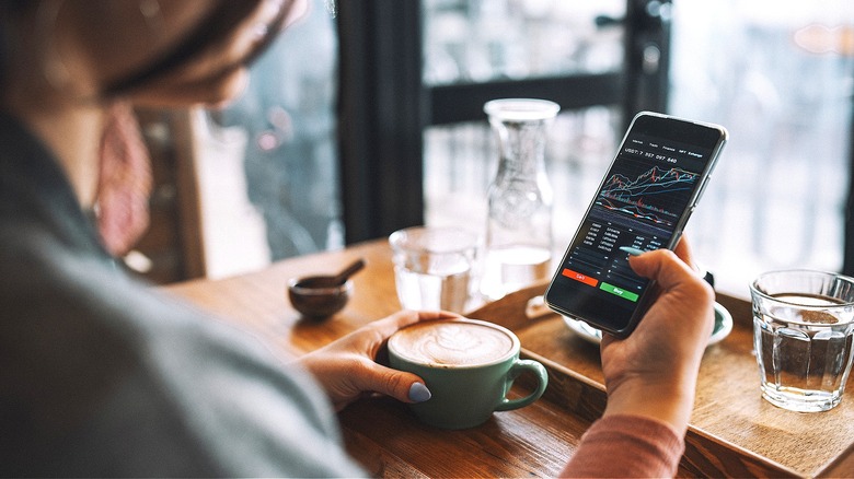 Person having coffee, reviewing stocks