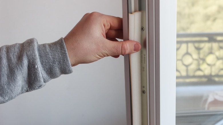 applying weatherstripping to a window