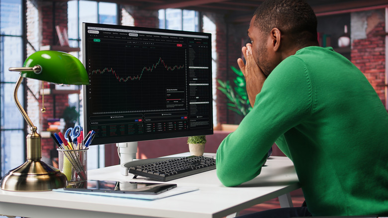 Man sitting at his computer day trading
