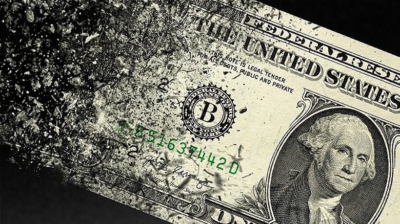 A one dollar bill disappearing