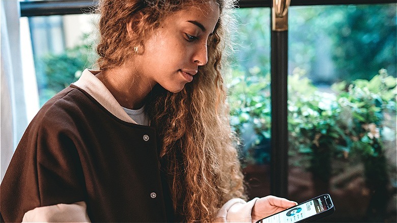 Person checking financials on phone