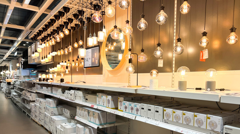 Shelves in an IKEA store showcasing home lighting equipment, including bulbs, light fixtures, and a variety of options.