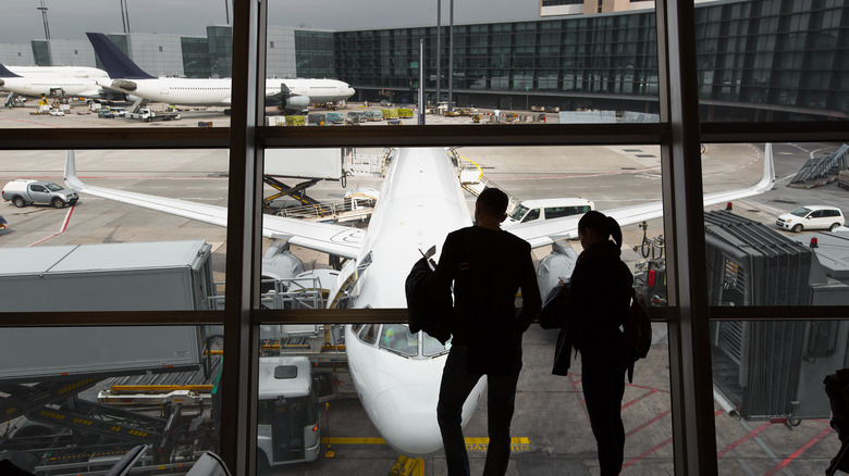 hopeful passengers looking at plane
