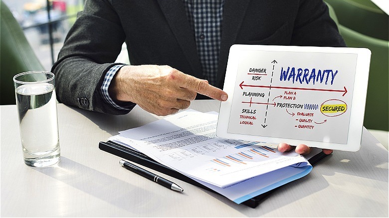 Person holding a warranty presentation