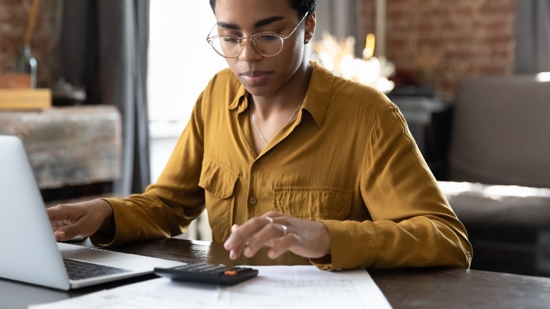 Person calculating bills and expenses