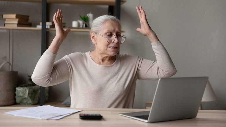 Frustrated older woman on a computer