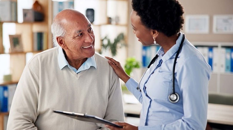 Elderly man talking with a doctor