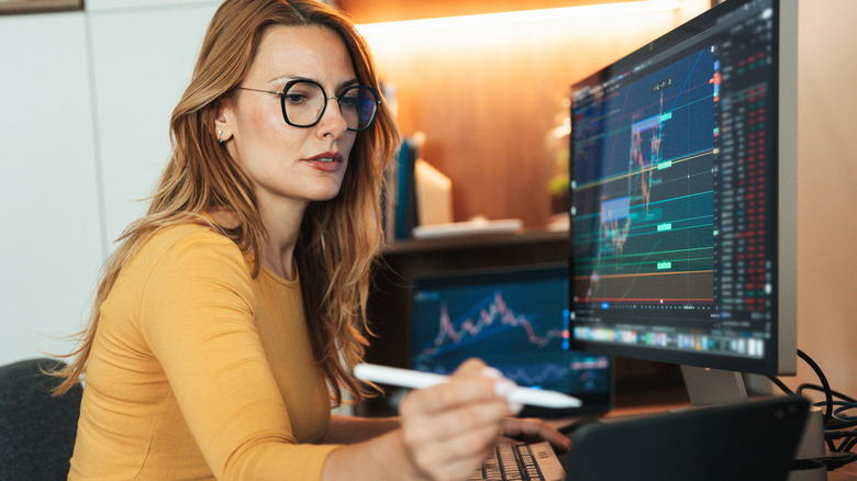 Woman examining stock market charts