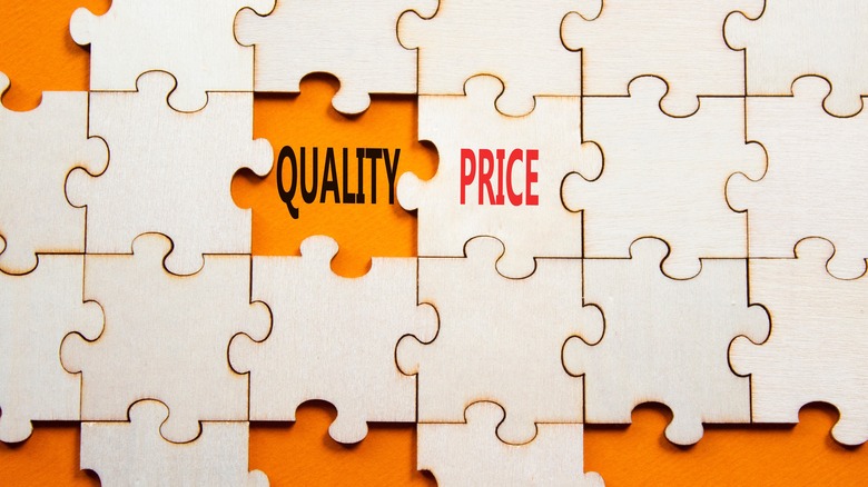 Orange and beige puzzle with words quality and price on them