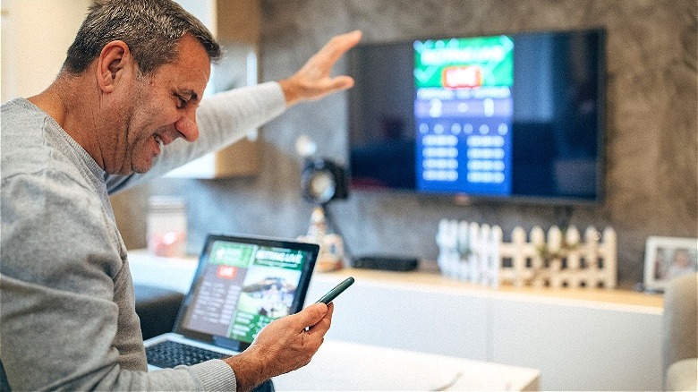 Person smiling at sports bet