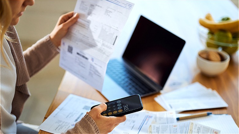 Person calculating costs on bill