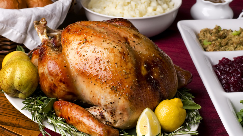 Golden roasted turkey on dinner table