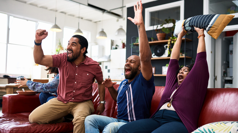 People cheering in living room