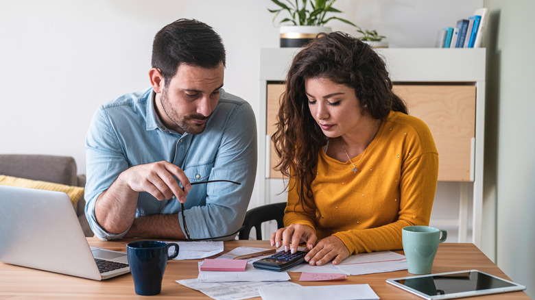 couple looking over financial details in front of computer