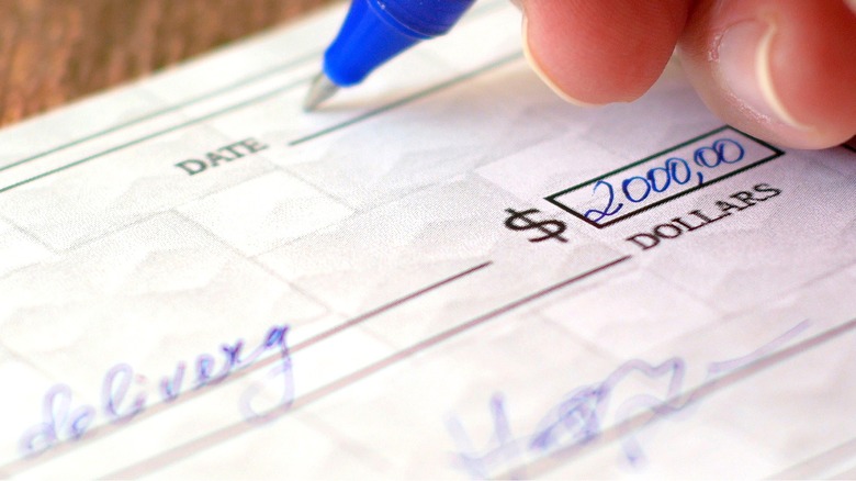 Someone writing out personal check