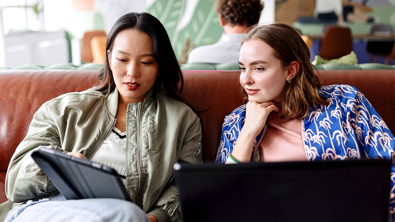 Two people looking at tablet