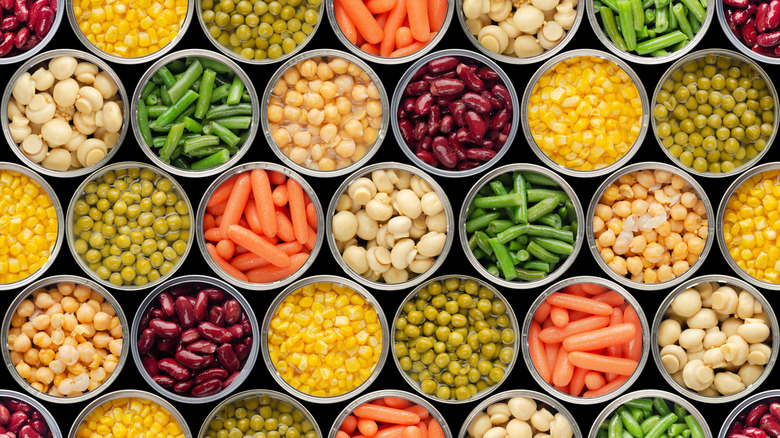 An overhead view of a colorful and attractive array of canned foods with their tops removed.