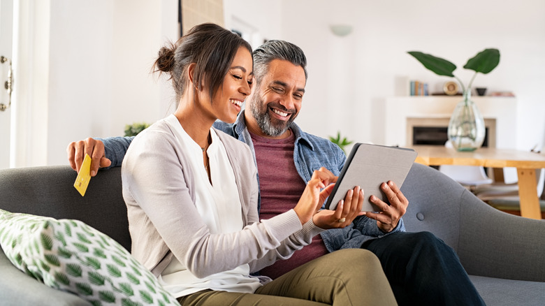 Couple on ipad with credit card