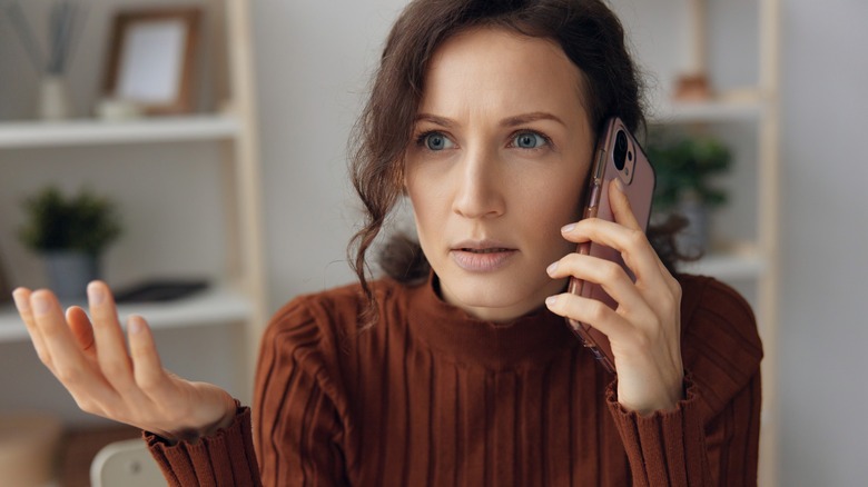 Frustrated woman on phone