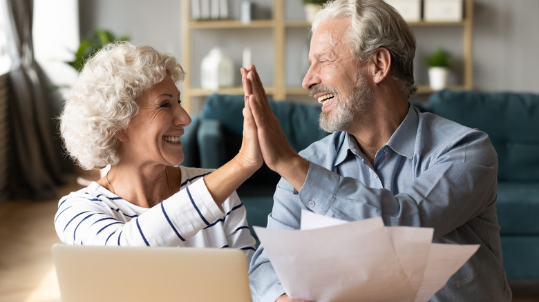 Mature people high fiving