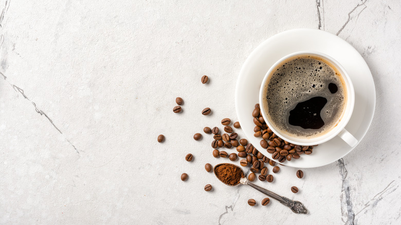 coffee cup on plate with beans