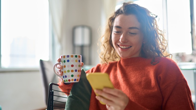 woman playing game on phone