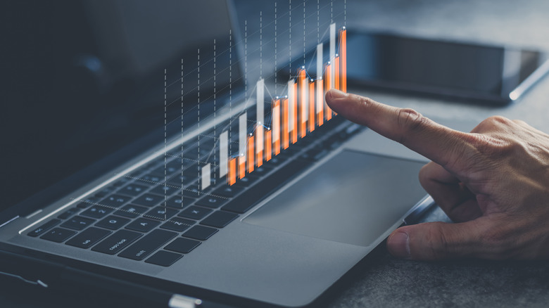 finger pointing at digital graph