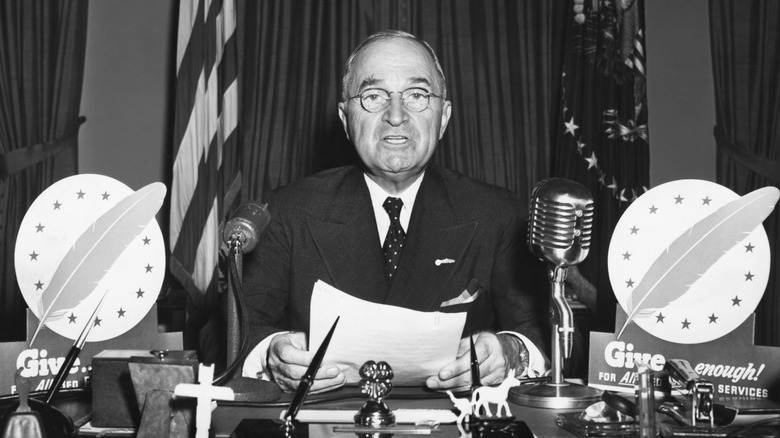 President Harry S. Truman speaks during a television address from the Oval Office.