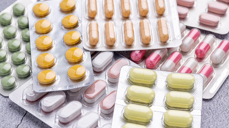 Variety of medicines and drug on a table.