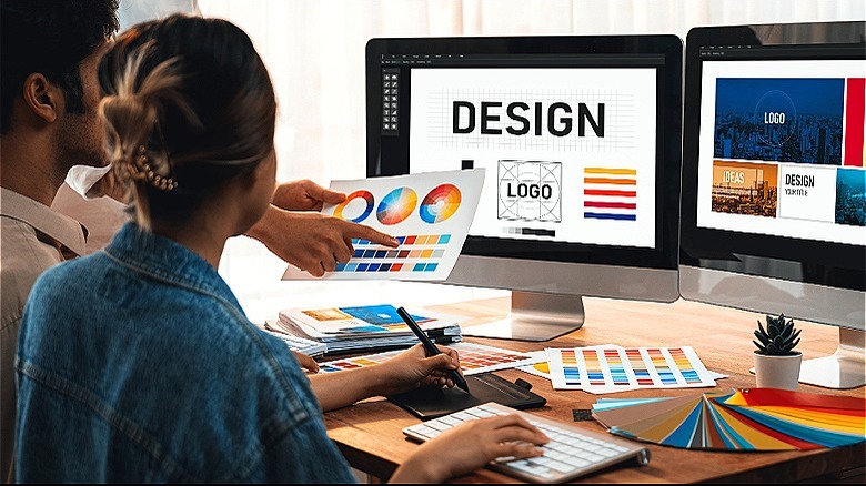 Two people reviewing graphics