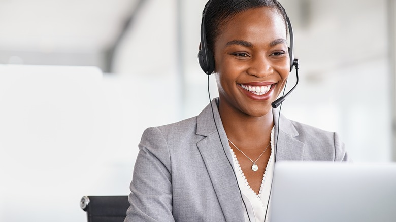Person smiling at laptop