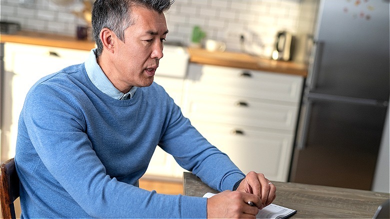 Person with notebook at laptop