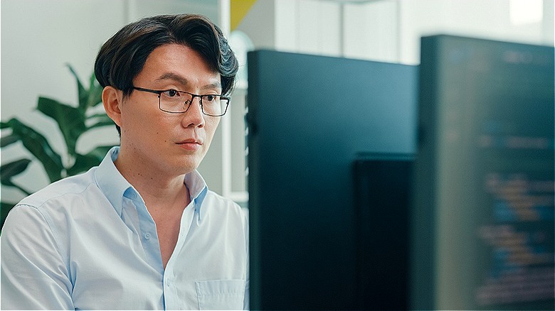 Person staring intently at monitor