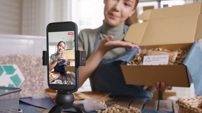 Person recording unboxing on phone