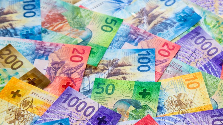 Various Swiss Franc banknotes on a table.